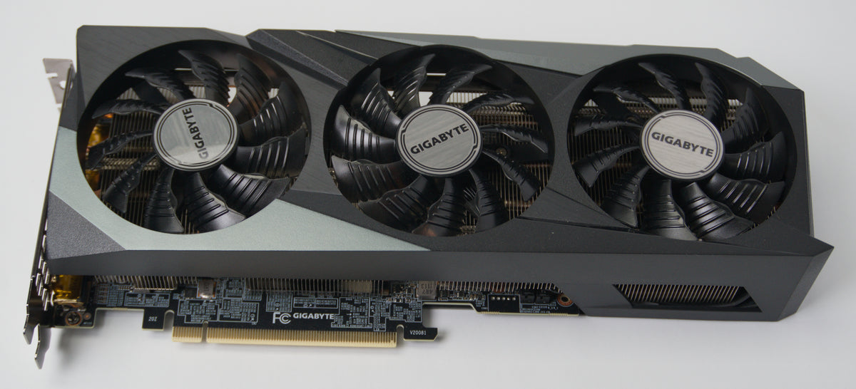 A Gigabyte graphics card with a three-fan cooling system, featuring a black and dark gray design.
