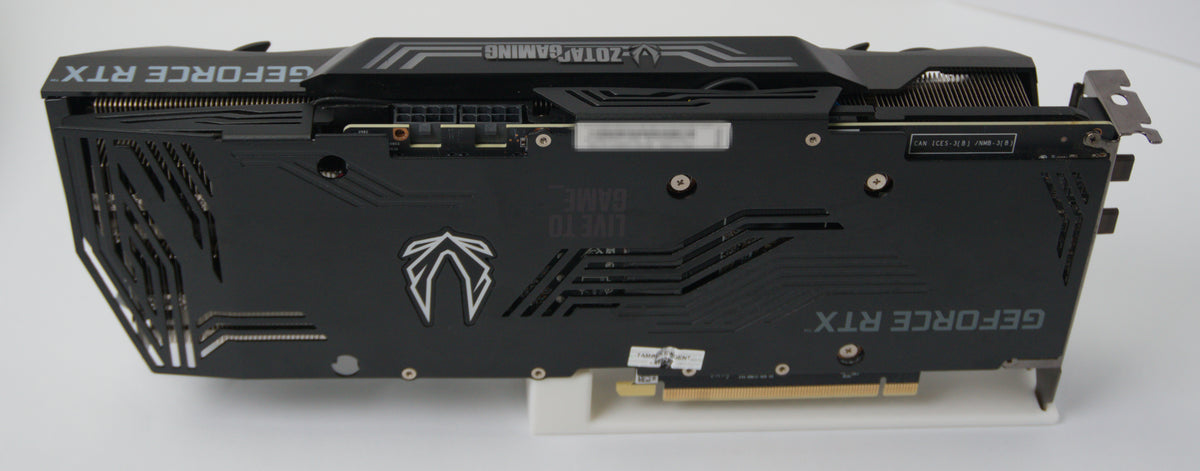 A black NVIDIA GeForce RTX graphics card with a dual-shroud cooling system, photographed from the back on a white background.